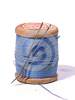 Sewing spool with a needle. A sewing needle.