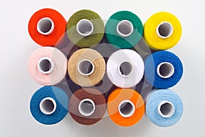 Sewing spools on white background
