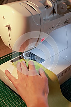 Sewing, stitching and overlocking on a machine at home