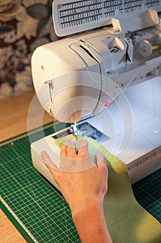 Sewing, stitching and overlocking on a machine at home