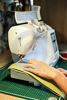 Sewing, stitching and overlocking on a machine at home