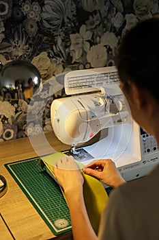 Sewing, stitching and overlocking on a machine at home
