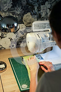 Sewing, stitching and overlocking on a machine at home