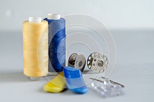 Sewing supplies and needlework accessories blue and yellow colors. Tailoring and craft concept