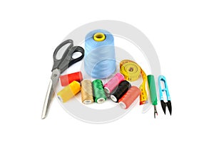 Sewing supplies (thread, scissors and measuring tape) isolated on a white
