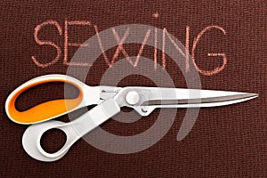 Sewing text underlined with scissors