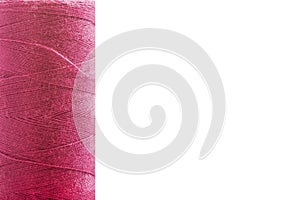 Sewing thread on bobbin on a white background