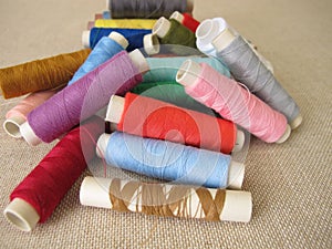 Sewing thread in different colors on farbric