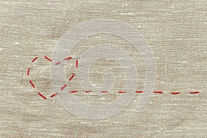 Sewing thread and for knitting, a red string in the form of a medical heart on instruments