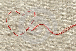 Sewing thread and for knitting, a red string in the form of a medical heart on instruments