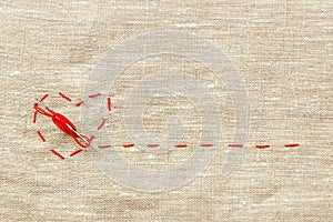 Sewing thread and for knitting, a red string in the form of a medical heart on instruments