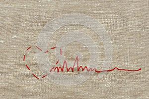 Sewing thread and for knitting, a red string in the form of a medical heart on instruments