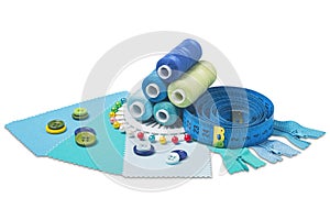 Sewing  thread, needle, bobbins, buttons, zipper  and  fabric samples  blue  color on isolated white  background