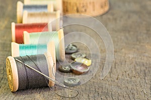 Sewing thread with needle and buttons