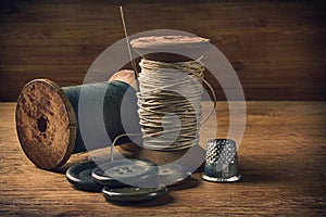 Sewing thread, needle and buttons