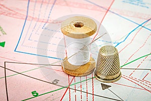 Sewing thread and thimble on pattern cutting