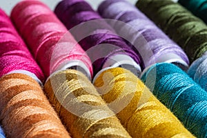 Sewing threads as a multicolored background close up