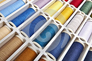 Sewing threads multicolored background closeup