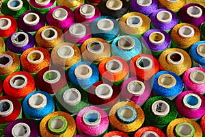 Sewing threads of various color on spindles
