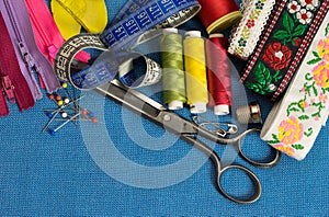 Sewing tools and accessories of tailor on blue background.