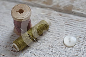 Sewing tools on white wood background. Tight and blurry focus.