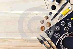 Sewing tools on wood background photo