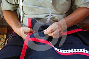 Women are sewing, tribal dress, Phuthai dress photo