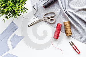 Sewing wokrshop. Textile, pattern, scissors, thread on white background top-down copy space