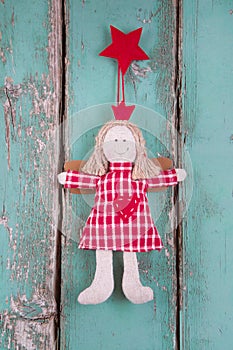 Sewn angel doll hanging on turquoise wood board - christmas