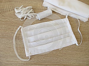 Sewn fabric face mask made of white cotton