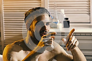Sex and erotica concept: guy in bathroom with involved look