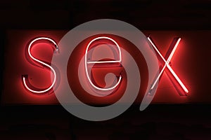 SEX hot red neon on black background