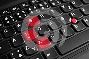 Sex sign highlighted in red on the laptop keyboard