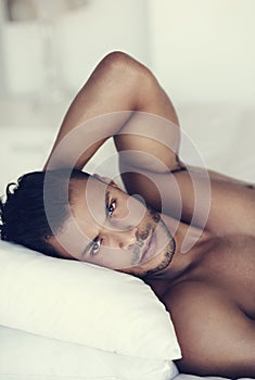 Sexiness is all in the attitude. a handsome young man in bed in the morning. photo