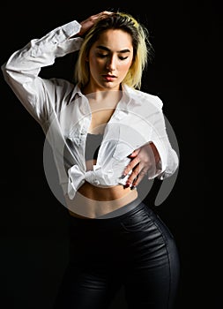 Sexual fetish concept. Portrait of sexy woman on black background. Wearing his shirt. Perfect body shapes. Sensual model