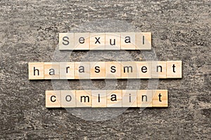 Sexual harassment complaint word written on wood block. Sexual harassment complaint text on table, concept