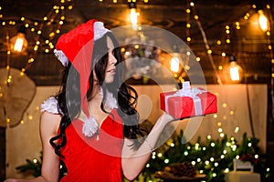 Sexual holidays. Desirable Santa girl. Gift for adults. Sexy gift. Sex shop. Attractive girl in erotic lingerie hold