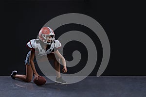 Sexual sportive woman running with rugby ball and screaming aggressively at black background. gender equality