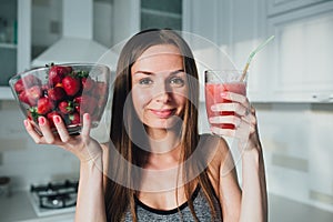 Sexual sports girl drinking a delicious smoothie with berries