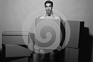 Sexuality and moving concept. Loader with shocked face covers nudity photo