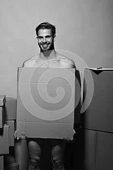 Sexuality and moving concept. Macho with smiling face covers nudity. Man with beard