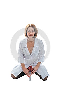Sexually doctor woman on isolated white background. Caucasian woman medic with big syringe with a red liquid.