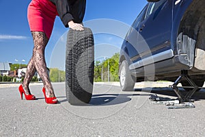 Sexually dressed woman repairing car