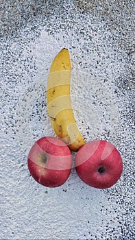 Sexually suggestive banana and red apples photo