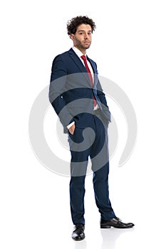 Sexy arabic man in elegant suit posing with hands in pockets