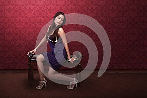 asian woman with purple dress sitting in sofa