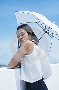 Sexy asian woman and white umbrella