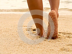 Sexy Asian women legs foot step on tropical sand beach. Walking female feet sand beach leaving footprints