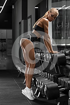 athletic girl working out in gym. Fitness woman doing exercise. beautiful in thong photo