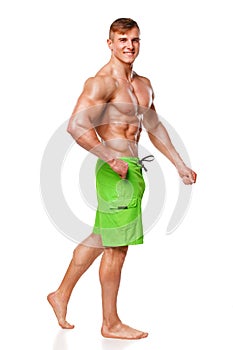athletic man showing muscular body, isolated over white background. Strong male nacked torso abs